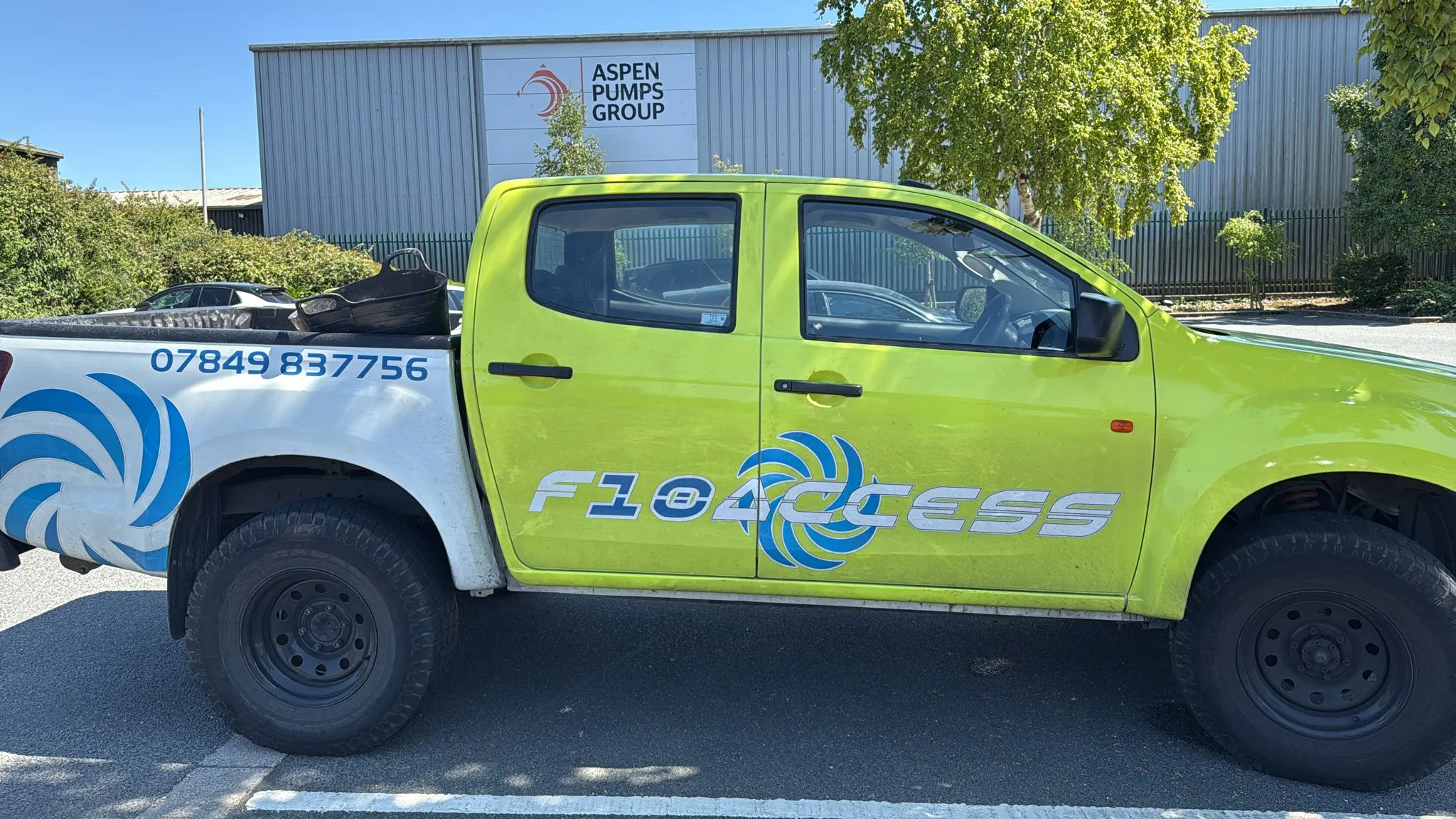 A yellow truck parked in a parking lot.
