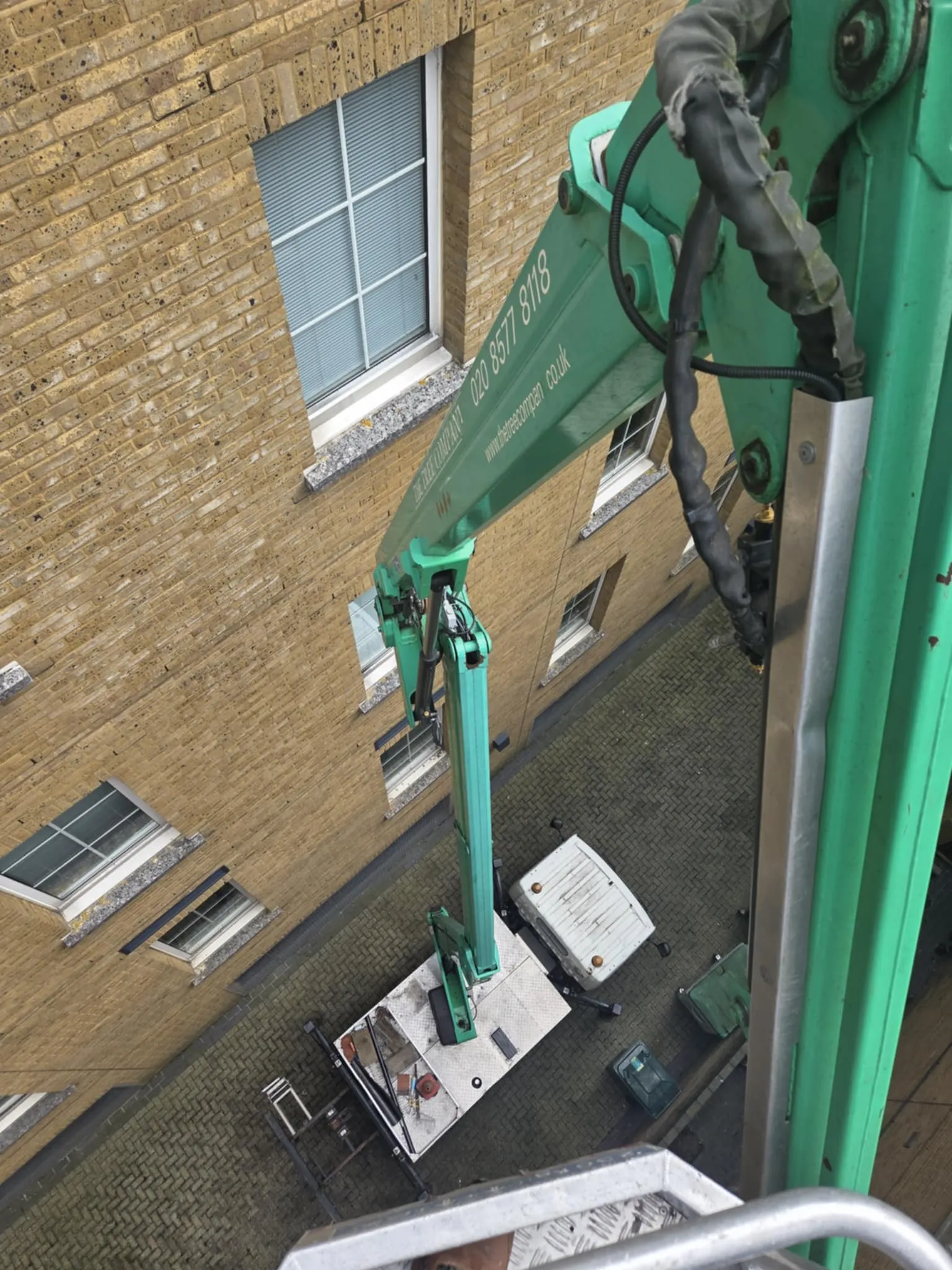 A crane that is on the side of a building.