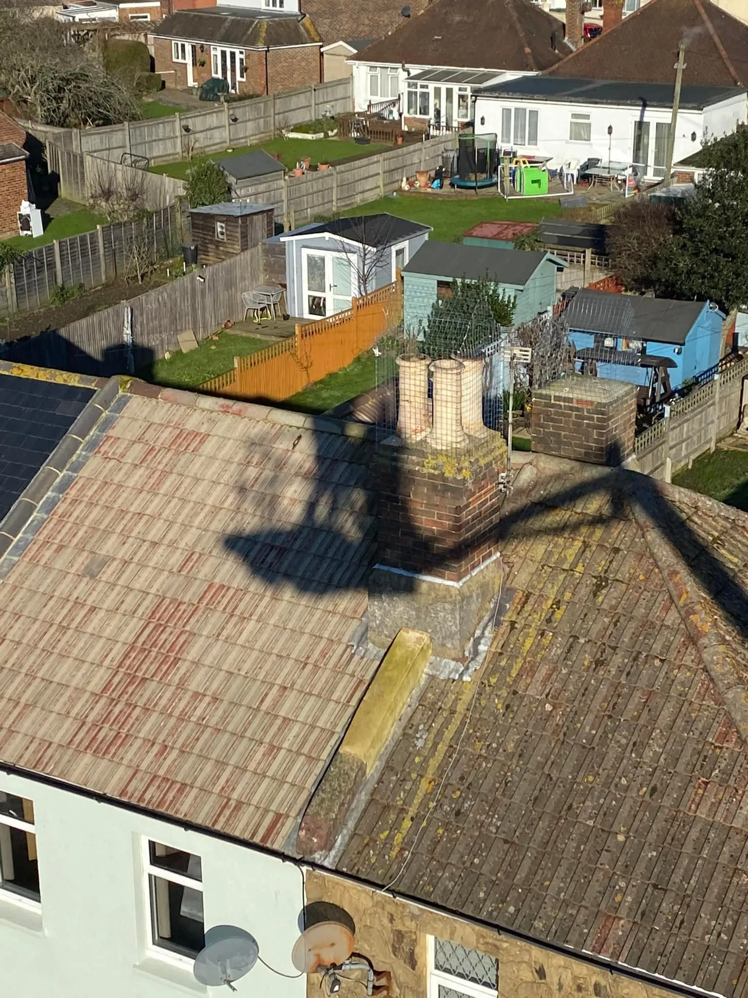 A shadow of a person on a roof.